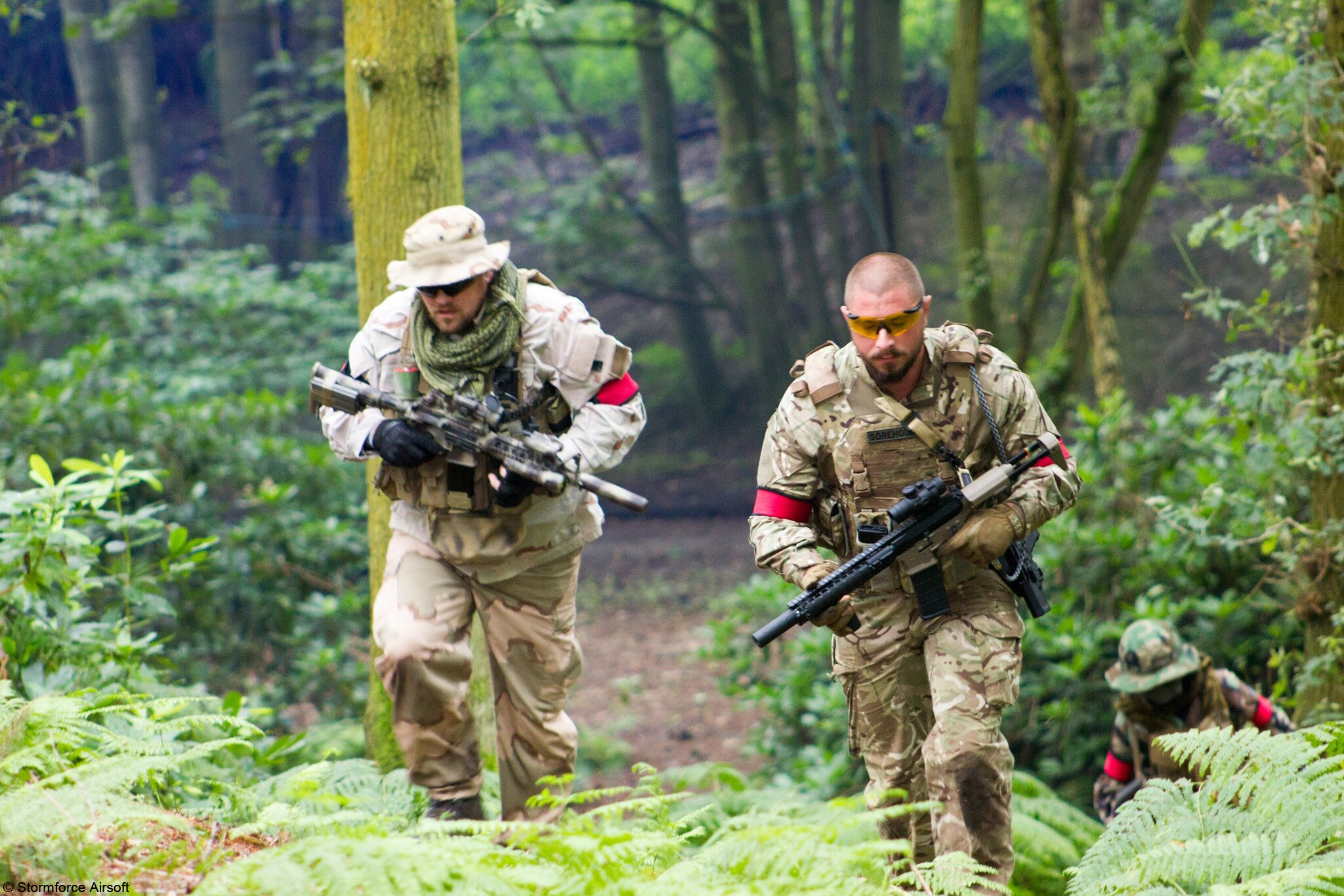 realistic woodland skirmish with electric airsoft guns and clothing